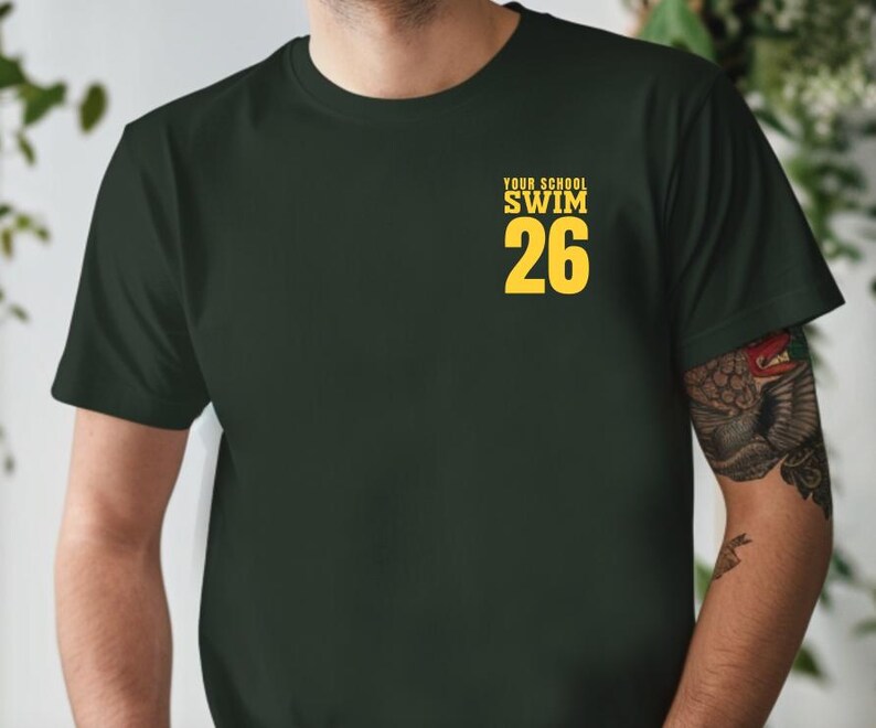 Example of Design on front of tee, yellow text on Forest. Add custom school or mascot name on top line.