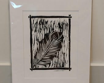 May include: Black and white print of a single feather in a frame. The feather is stylized and has a textured look.