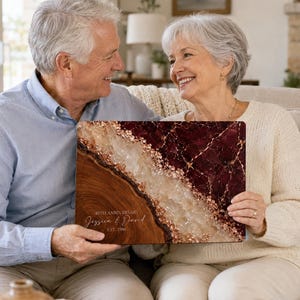 May include: A rectangular wooden plaque featuring a deep burgundy marble-effect section, a central band of textured gold and white crystalline detail, and a natural wood grain side. The text reads 40TH ANNIVERSARY Jessica & David EST. 1986.