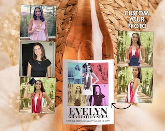May include: A rose-colored wine bottle with a custom label featuring multiple photos of a graduate. The label reads "EVELYN GRADUATION'S ERA" and "ARIZONA STATE UNIVERSITY | CLASS OF 2026". The bottle has a rose gold top and is surrounded by a woven background.