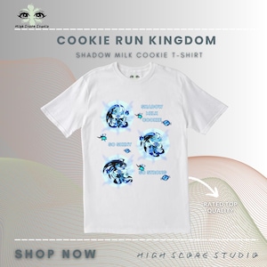 May include: White t-shirt featuring a design from Cookie Run Kingdom. The shirt displays four circular graphics with a blue and white character design, along with the text "Shadow Milk Cookie", "So Shiny", and "So Strong". The shirt also has the text "Shop Now" and "High Score Studio".