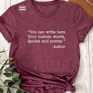 May include: A maroon t-shirt with the text "You can write here Your custom words, Quotes and poems." The shirt has a crew neck and short sleeves. The text is in white, and the shirt is made of a soft material.