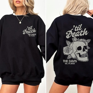 May include: Black sweatshirt with white trim featuring the text "'til Death" and "THE DAVIS 05.19.2025" in a stylized font. The back of the sweatshirt displays a skull with roses.