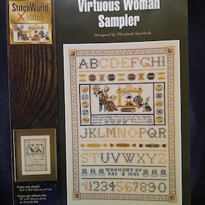 May include: A cross-stitch sampler pattern featuring the alphabet, numbers, and a woman working at a spinning wheel. The pattern is titled "Virtuous Woman Sampler" and designed by Elizabeth Spurlock. The frame size is 14.5 x 18.5 inches (38.8 cm x 47 cm).