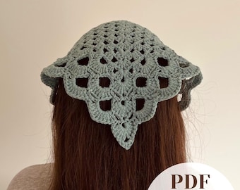 May include: A sage green crochet headscarf featuring a triangular shape with an openwork granny square pattern and scalloped edges. The image includes a circular white overlay with the text PDF Easy-to-Follow in dark brown lettering.
