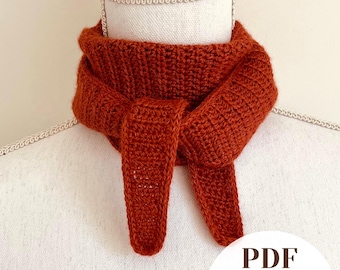 May include: A rust-colored crochet neck scarf featuring a ribbed texture and a tied front design. The scarf is displayed on a mannequin. A circular white graphic in the bottom right corner contains the black text PDF Easy-to-Follow.