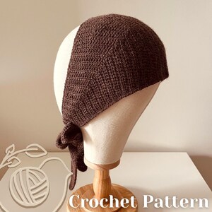 May include: A dark brown crochet head covering is displayed on a mannequin head. The head covering is tied at the nape of the neck. The words "Crochet Pattern" are visible at the bottom of the image.