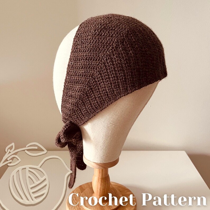 May include: A dark brown crochet head covering is displayed on a mannequin head. The head covering is tied at the nape of the neck. The words "Crochet Pattern" are visible at the bottom of the image.