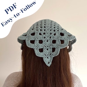 May include: A crocheted head covering in a soft teal color. The head covering has an open, lacy design with a scalloped edge. The text "PDF Easy-to-Follow" is in the upper left corner. The head covering is shown from the back.