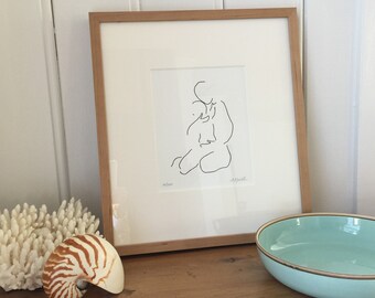 May include: A framed black and white line drawing of a person sitting with their arms around their knees. The drawing is on a white background and is framed in a light wood frame. The drawing is signed "M. Smith" in the bottom left corner and "M. Smith" in the bottom right corner.
