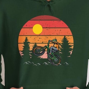 Mountain Adventure: T-shirt with Cyclist Print Against Sunset | Hoodies and Sweatshirts for Nature Lovers