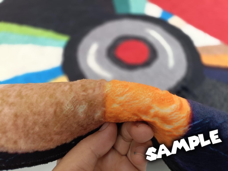 May include: Close-up of a section of a colorful rug with a brown and orange design. The word "SAMPLE" is printed in white across the bottom right corner of the image.