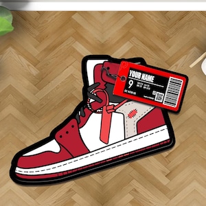 May include: Red and white cartoon sneaker with a black outline and a white tag that says "YOUR NAME" with a barcode and the number "9".