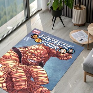 May include: A rectangular area rug featuring a Marvel Fantastic Four comic book cover graphic. The design displays the orange, rock-skinned character The Thing in the foreground, with the comic title, issue number 601, and character portraits.