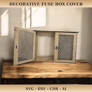 May include: Decorative fuse box cover made of light-colored wood with a lattice design on the doors. The box is open, revealing the interior. The text "DECORATIVE FUSE BOX COVER" is at the top. The bottom text reads "SVG - DXF - CDR - AI".