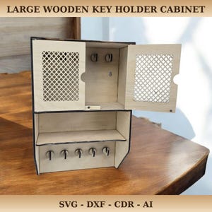 May include: A light-colored wooden key holder cabinet with a lattice design on the doors. The cabinet has a top section with key hooks and a lower shelf with additional hooks. The text "LARGE WOODEN KEY HOLDER CABINET" is at the top.