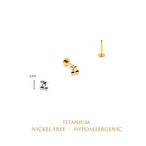 May include: A silver-colored cherry-shaped stud earring and a gold-colored cherry-shaped stud earring with a flat back post. The silver earring is labeled with a 3.6mm measurement. Text reads: TITANIUM, NICKEL-FREE, HYPOALLERGENIC.