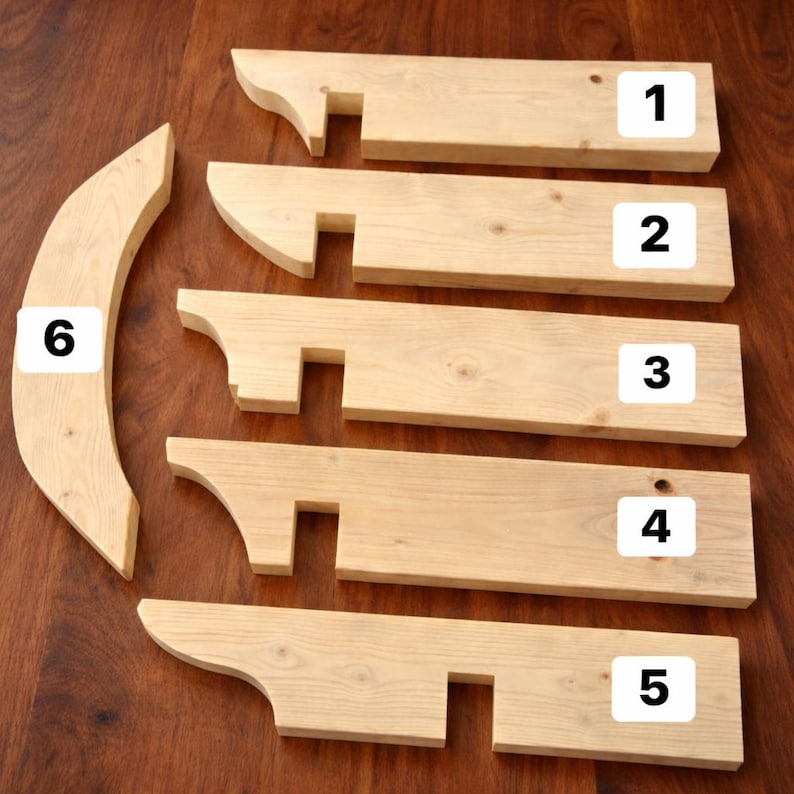 May include: Six unfinished light-colored wooden components for assembly. Five rectangular boards labeled 1 through 5 feature a curved end and a square notch. One curved, crescent-shaped piece is labeled 6. The wood grain is visible throughout.
