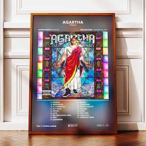 May include: A framed poster for the album "AGARTHA" by VALD. The artwork features a stained-glass style design with a central figure in white and red robes. The album title and tracklist are displayed.