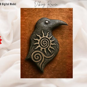 May include: A 3D digital model of a Viking raven, with the text "Viking Raven" at the top. The raven is dark gray with a gold sun and spiral design on its chest. The background is a copper-colored square.