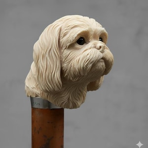 May include: A detailed sculpture of a dog's head, likely a Shih Tzu, in a cream color. The dog's fur is intricately carved, with a focus on the face and long, flowing hair. The sculpture is mounted on a brown and silver pole.