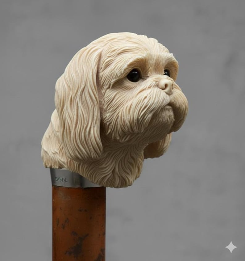 May include: A detailed sculpture of a dog's head, likely a Shih Tzu, in a cream color. The dog's fur is intricately carved, with a focus on the face and long, flowing hair. The sculpture is mounted on a brown and silver pole.