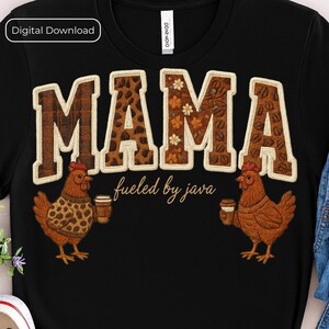May include: Black t-shirt with the word "MAMA" in a brown, textured design. The letters are outlined in white. Two cartoon chickens holding coffee cups flank the text. The phrase "fueled by java" is below the word "MAMA".