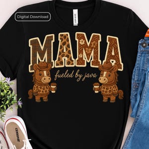 May include: Black t-shirt with the word "MAMA" in brown, patterned letters. Below the word "MAMA" is the phrase "fueled by java". Two cartoon horses wearing cowboy hats and sweaters are holding coffee cups.