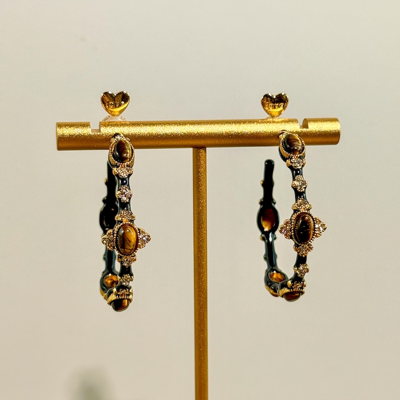Close-up of textured gold bamboo hoop earrings featuring tiger’s eye stones and sparkling rhinestones, elegant handmade detailing