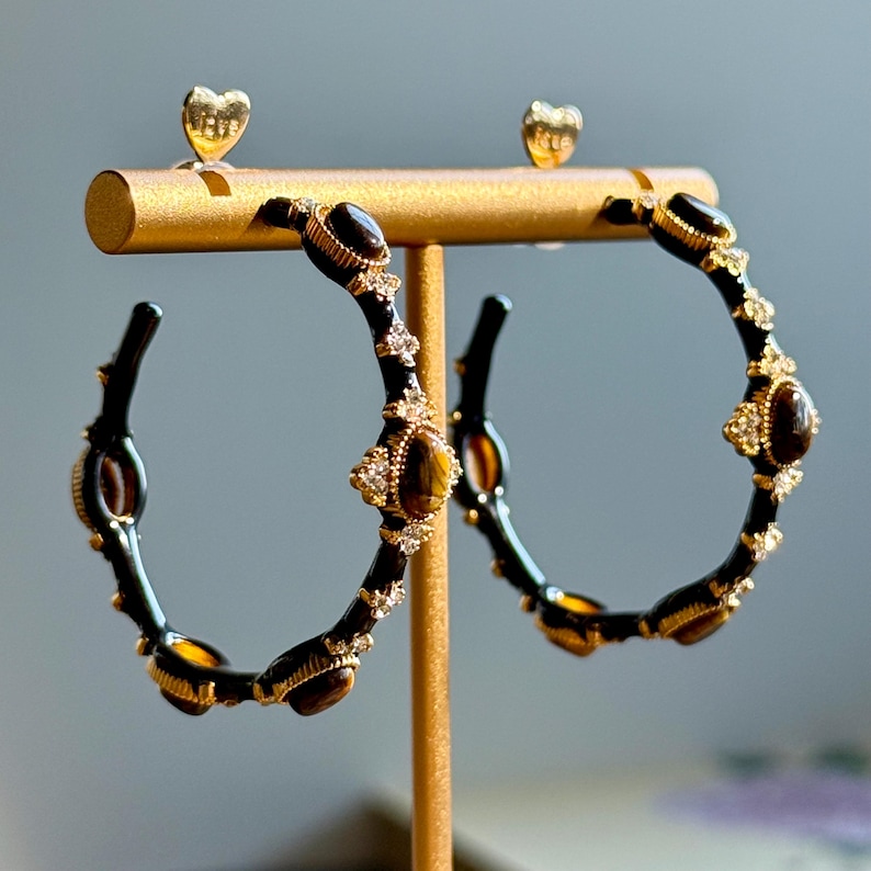 18K gold tone bamboo hoop earrings with tiger’s eye stones and rhinestone accents, textured gold design reflecting warm brown glow