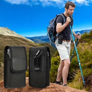 May include: Two black nylon phone cases with belt clips. One case has a leather patch. The other case has a metal carabiner clip. A person is wearing a similar case on their belt while hiking in the mountains.