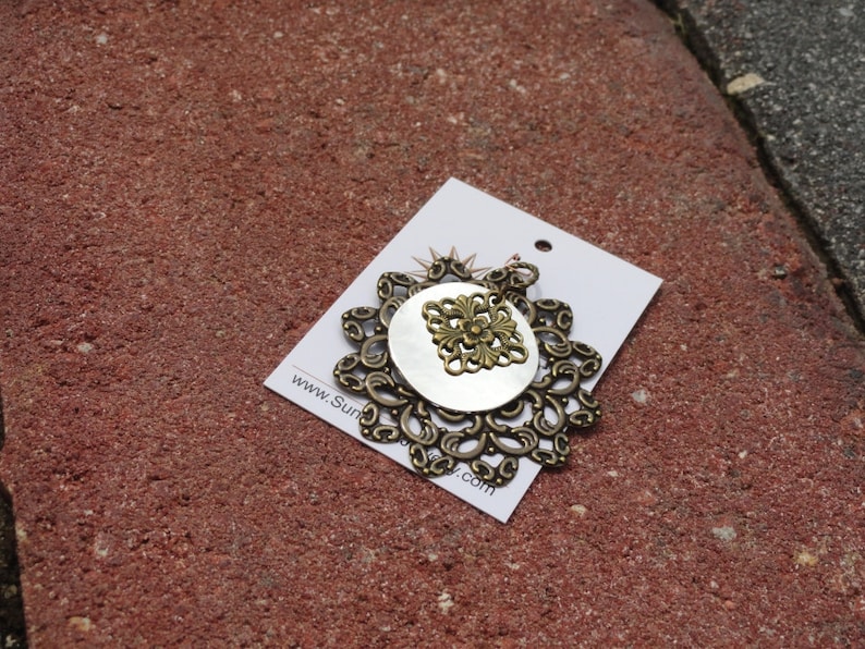 Surprise pendant in antique gold and shiny silver Style #1345B