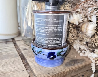 May include: A close-up of a blue and white ceramic garlic press with a black plastic handle. The press is assembled and ready to use. The text on the label reads: "Assembly is shown in the picture. All contents (S) and ceramic piece lower (6) assembled."