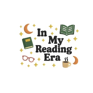 May include: Embroidered design featuring the phrase "In My Reading Era" in black, with illustrations of books, glasses, a coffee cup, moons, and stars in green, orange, and gold on a white backdrop.