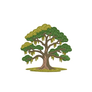 May include: An embroidered tree design featuring a brown trunk, green and yellow foliage, and hanging yellow fruit. The tree is set against a white background, with a patch of green grass at the base. The design is detailed and textured.