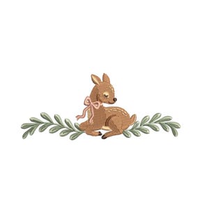 May include: Embroidered image of a fawn with a pink bow, lying on a bed of green leaves. The fawn is brown with a textured appearance, and the leaves are a muted green. The design is set against a white background.