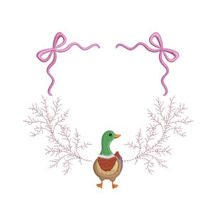 May include: An embroidered design featuring a green, brown, and orange duck with a pink bow above and a floral design. The duck is centered, with the bow and floral elements arranged around it on a white background.