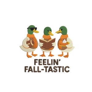 Pode incluir: Um design de bordado com três patos-reais usando cachecóis laranja. O pato da esquerda usa óculos de sol e segura uma bola de futebol americano, o central segura um livro aberto e o da direita segura uma torta. Texto: FEELIN' FALL-TASTIC.