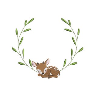 May include: An embroidered design featuring a sleeping fawn with brown fur and white spots, nestled within a green leafy wreath. The fawn has closed eyes and small antlers, perfect for baby decor or nursery projects.