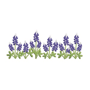 May include: An embroidery design featuring a horizontal row of bluebonnet flowers. Each flower has deep purple petals with white tips, supported by green stems and palmate leaves. The design is rendered in a clean, stitched style on a white background.