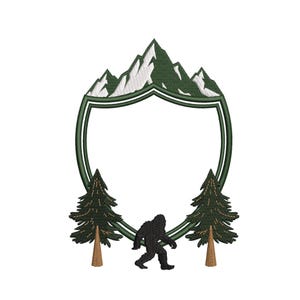 May include: An embroidered design featuring a green shield shape with a mountain range at the top. Two green pine trees flank a black silhouette of Bigfoot. The design is on a white background.