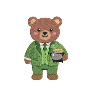 Könnte beinhalten: Gestickter brauner Bär mit grünem Anzug, Weste und Krawatte, der einen Topf Gold hält. Der Bär hat ein Kleeblatt am Revers und lächelt. Das Design befindet sich auf weißem Hintergrund.