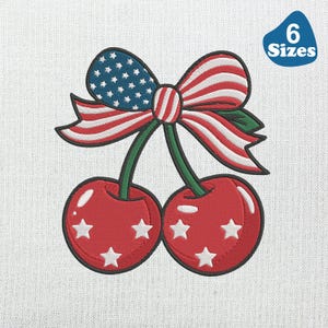 May include: Embroidered design of two red cherries with white star accents, connected by green stems. A bow, featuring the American flag design, sits above the cherries. The image includes a blue tag with the text "6 Sizes".