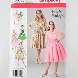 May include: Simplicity 1459 K5 vintage sewing pattern featuring 1950s style dresses. The pattern includes multiple dress designs with varying necklines, sleeves, and skirt styles. The cover displays two women wearing dresses made from the pattern.