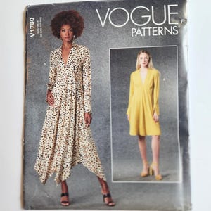 May include: A Vogue Patterns sewing pattern envelope V1780 featuring two dress designs. One view shows a long-sleeved, V-neck dress with an asymmetrical hem in a black and white animal print. The other view shows a solid yellow, long-sleeved, V-neck dress.