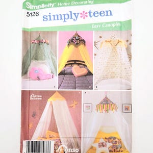 May include: A Simplicity pattern for simply teen easy canopies. The pattern features several canopy designs, including those with floral, heart, and star accents. The package includes the text "Simplicity Home Decorating" and "simply*teen".