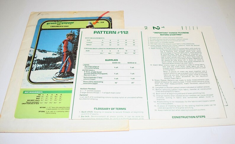 May include: Vintage Green Pepper Children's Wear pattern #112. The pattern includes instructions and measurements for sizes 4-12. The cover features a child in a red, blue, and white ski suit on a snowy mountain.