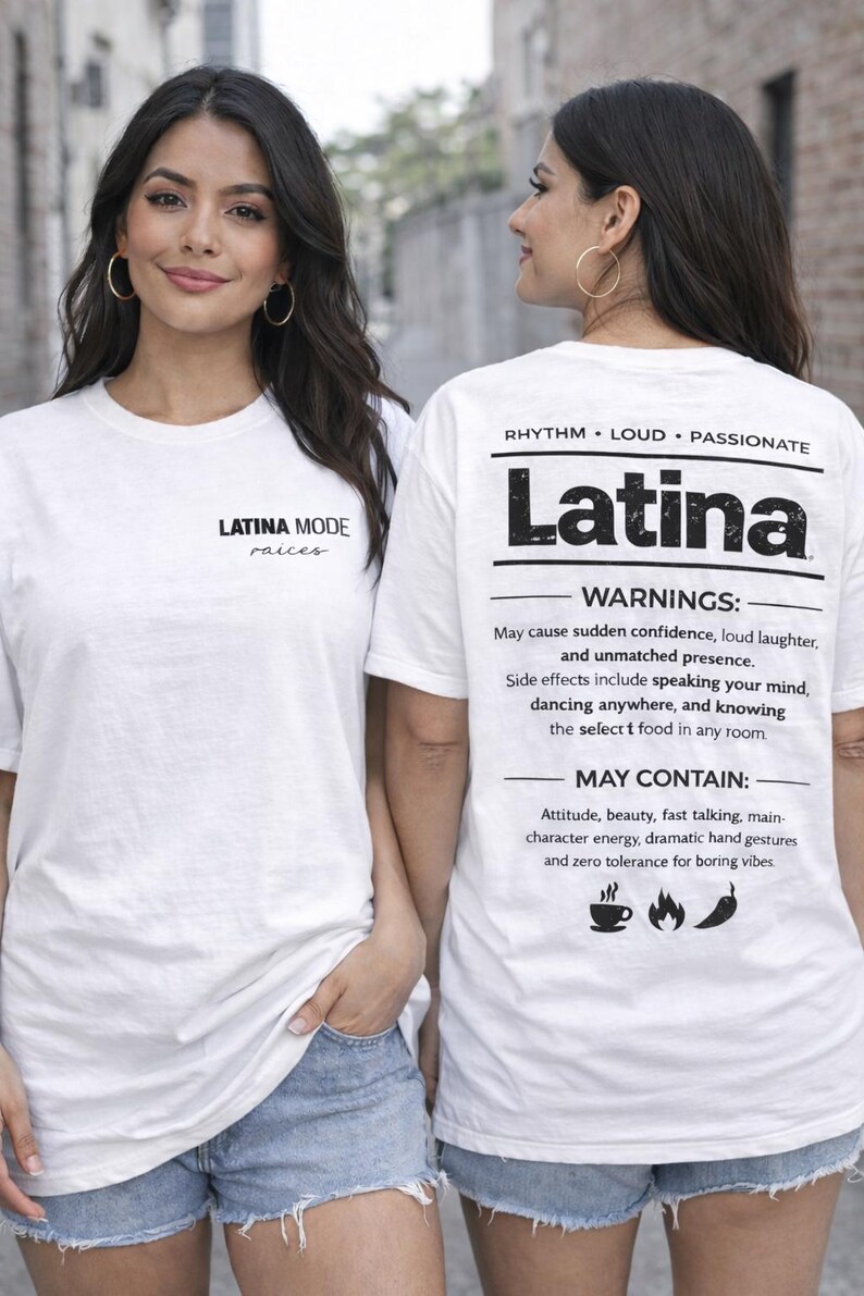 May include: Two women wearing white t-shirts with the word "Latina" printed on the back. The front of the shirt has the text "LATINA MODE raices". The back of the shirt also has the words "RHYTHM LOUD PASSIONATE" and a list of warnings and may contain items.