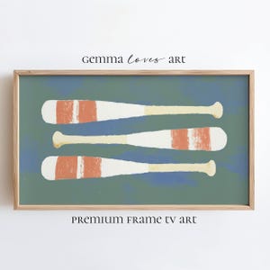 Könnte beinhalten: Gerahmter Kunstdruck mit drei weißen Rudern mit orangefarbenen Streifen vor einem blau-grünen Hintergrund. Das Kunstwerk befindet sich in einem Holzrahmen. Der Text "gemma loves art" und "PREMIUM FRAME TV art" ist auf dem Bild aufgedruckt.