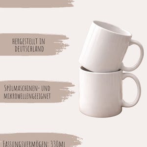May include: Two white ceramic mugs stacked on top of each other. Each mug has a curved handle and a cylindrical body. The capacity of each mug is 330ml.